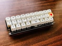 a white keyboard sitting on top of a wooden table