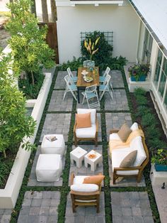 an outdoor living area with chairs, tables and couches in the middle of it