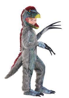 a child in a costume that looks like a dinosaur with claws and tail, standing on one leg