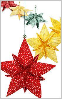 three paper stars hanging from strings with polka dotes on them, one red and one yellow