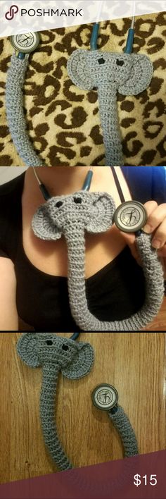 a woman is holding up a crocheted snake