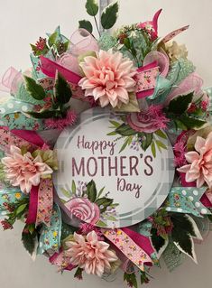 a mother's day wreath with flowers and ribbons