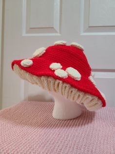 a knitted red hat with white dots on it