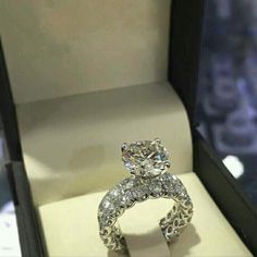 a diamond ring is displayed in a box