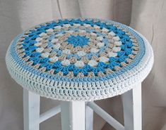 a crocheted stool sitting on top of a white table