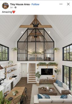 a living room filled with furniture and lots of windows next to a stair case in front of a window