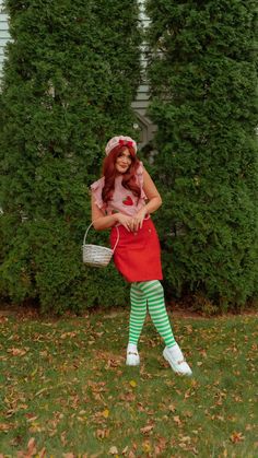 a woman in green and white striped tights holding a basket