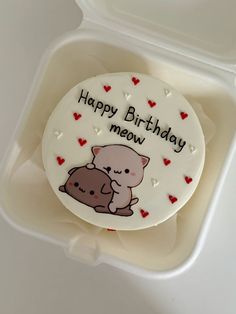 a birthday cake with an image of a cat and a dog on it in a plastic container