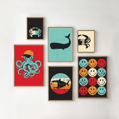 there are four framed pictures on the wall with an octopus, whale, and crab