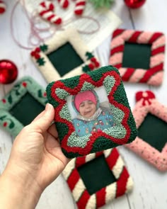 someone is holding up a christmas ornament to show it's photo on the front