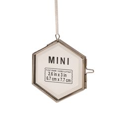 an ornament hanging from a string with the word mini on it's side