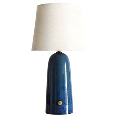 a blue table lamp with a white shade