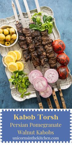 kebab tosh with lemons, onions and other vegetables on a platter