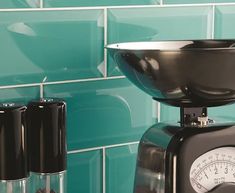 a kitchen scale with a bowl on top of it next to two salt and pepper shakers