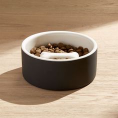 a dog bowl filled with food on top of a wooden table