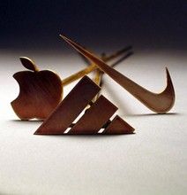 an apple and two wooden arrows on a white surface