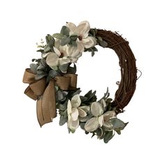 a wreath with white flowers and green leaves