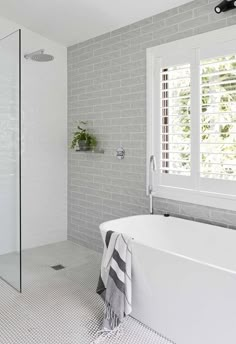 a white bath tub sitting next to a window