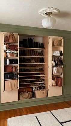 the closet is full of purses, shoes and handbags on shelves in it