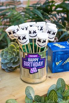 a tin can filled with marshmallows on top of a table