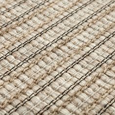 close up view of woven fabric textured with natural colors and lines in neutral tones