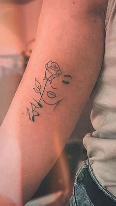 a woman with a rose tattoo on her arm