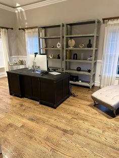 an office with wooden floors and white walls