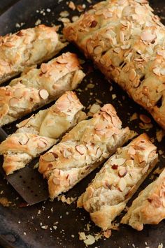 sliced almond scones sitting on top of a baking sheet