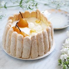 a cake on a plate with flowers in the background