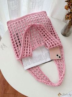 a pink bag sitting on top of a white table