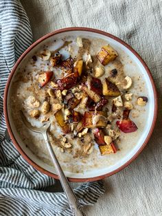 a bowl filled with oatmeal and nuts on top of a table cloth