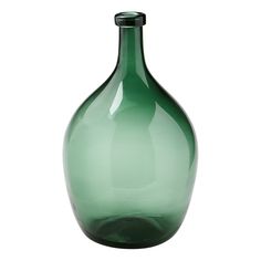 a green glass vase sitting on top of a white table