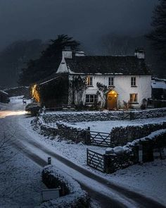 a white house sitting on the side of a snow covered road