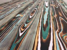 an abstract painting with blue, green and brown colors on it's surface is shown