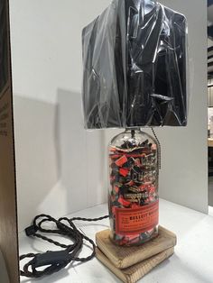 a lamp made out of a jar with plastic wrap around it