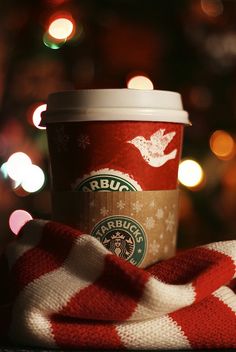 a starbucks cup wrapped in a red and white blanket