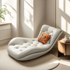 a white chaise lounge chair with an orange pillow