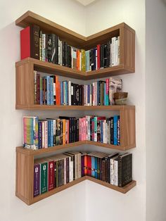 a corner book shelf with several books on it