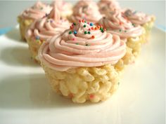 cupcakes with pink frosting and sprinkles on a white plate