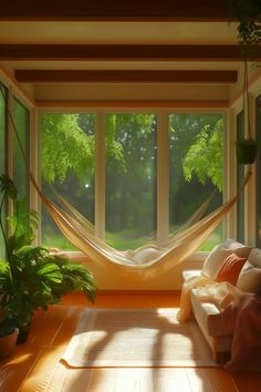 a hammock hanging in the middle of a room with large windows and potted plants