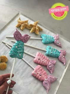 there are many colorful candy lollipops on the stick with toothpicks in them