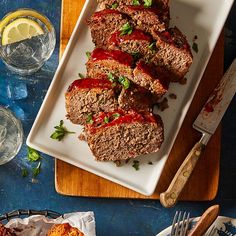 sliced meatloaf with ketchup and garnish on a white plate