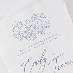 a wedding card with the words family and trees on it, sitting on top of a piece of paper