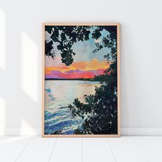 a painting hanging on the wall next to a white floor with a tree in front of it