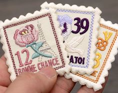 someone is holding two different stamps in their left hand, one with the number twenty and one with the word'imagine change '