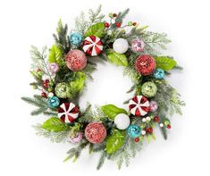 a christmas wreath with candy canes and greenery on white background, top view