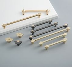 an assortment of handles and knobs on a gray surface