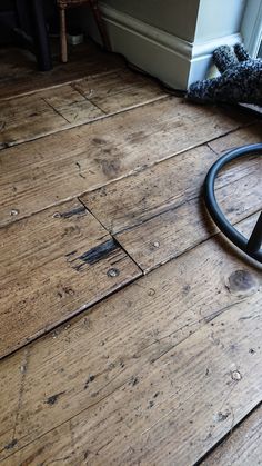 a wooden floor with a metal ring laying on it's side next to an open door