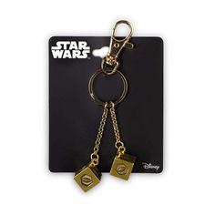 star wars keychain with two cubes attached to it's sides, on a black card