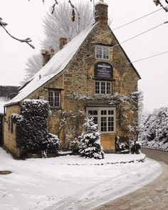 an old stone building with snow on the ground